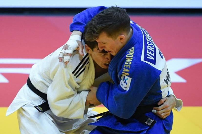Turkmenistan's Aybek Omirov fights against Belgium's Jorre Verstraeten (blue) in the men's -60kg qualification round bout of the Judo World Championships at the Papp Laszlo Arena in Budapest, Hungary on June 13, 2025.  Ferenc ISZA / AFP