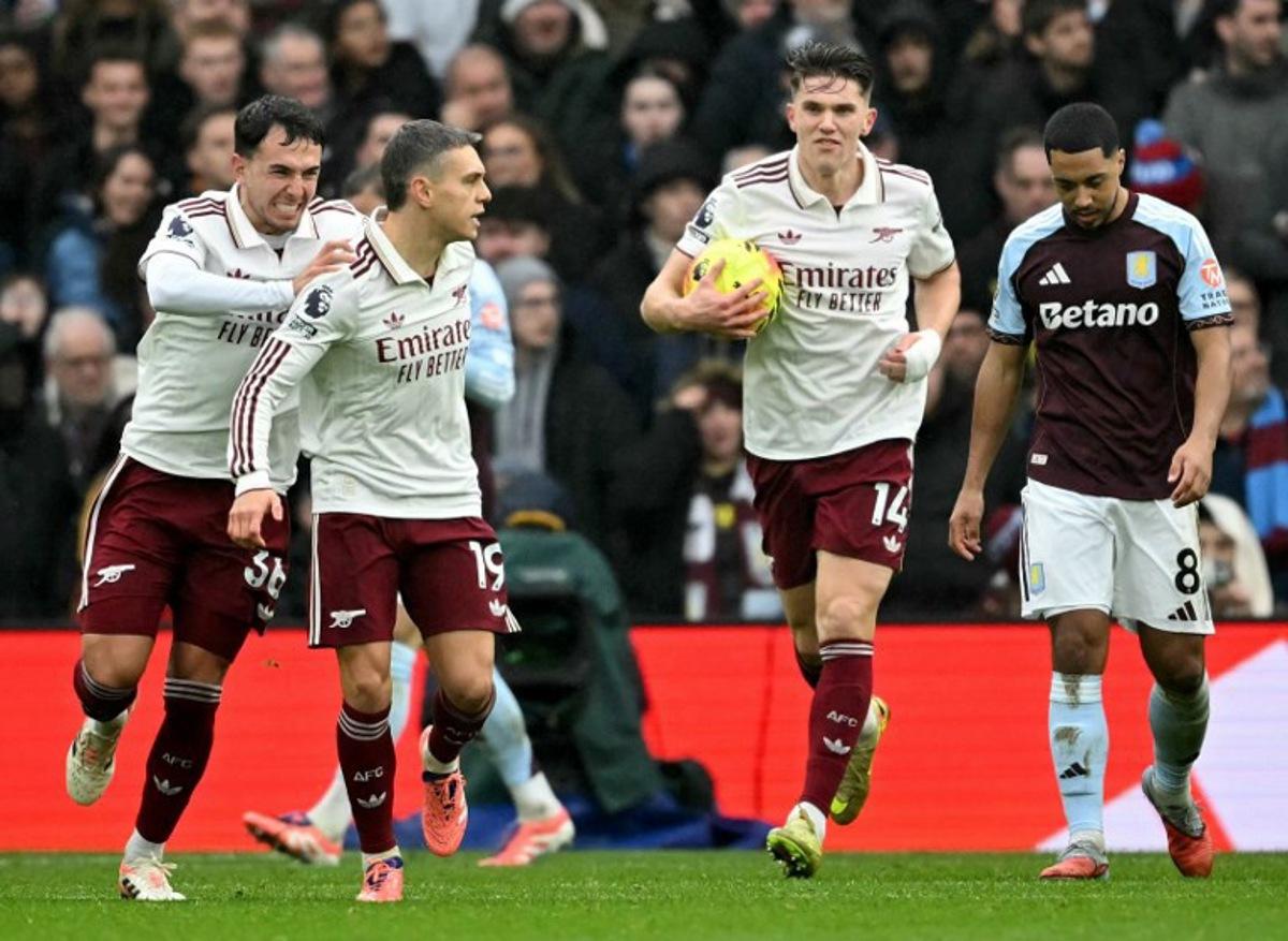 Arsenal's Belgian midfielder #19 Leandro Trossard (2L) celebrates after scoring the equalising goal during the English Premier League football match between Aston Villa and Arsenal at Villa Park in Birmingham, central England on December 6, 2025.  JUSTIN TALLIS / AFP
