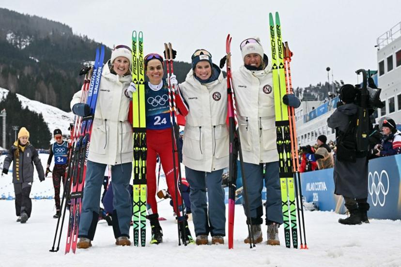 Norway's Heidi Weng (2ndL) poses with her teammates (From L) Norway's Karoline Simpson-Larsen, Norway's Kristin Austgulen Fosnaes and Norway's Astrid Oeyre Slind after she crossed the finish line for Norway to win the gold medal during the cross-country women's 4 x 7,5km relay event of the Milano Cortina 2026 Winter Olympic Games at Tesero Cross-Country Skiing Stadium in Lago di Tesero (Val di Fiemme), on February 14, 2026.  Javier SORIANO / AFP