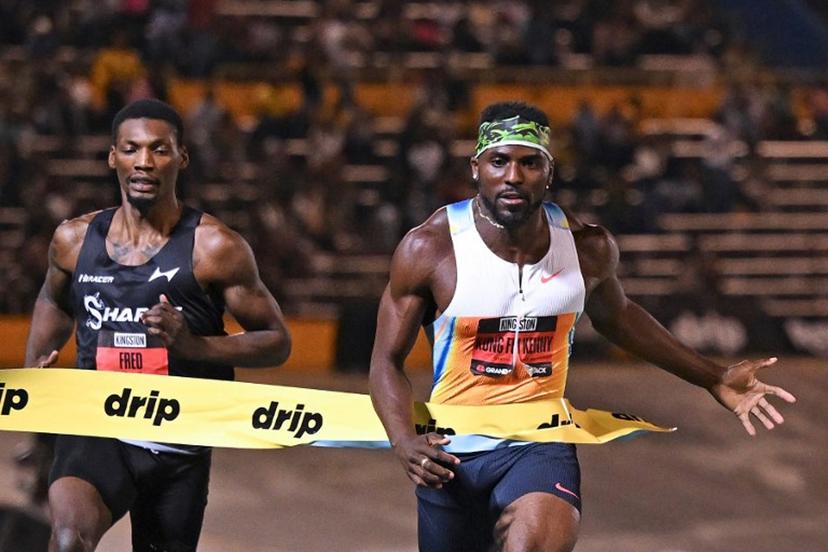 USA's Kenneth Bednarek (R) of team Nike crosses the finish line in first place ahead of USA's Fred Kerley (L) in the men's men 100m short sprint during the Grand Slam Track competition at the National Stadium in Kingston, Jamaica on April 4, 2025.  Ricardo Makyn / AFP