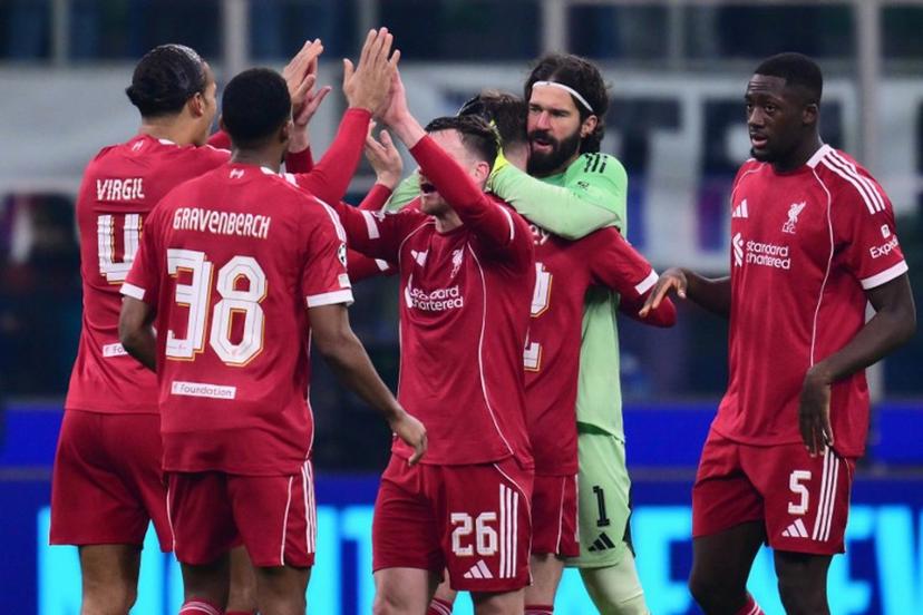 Liverpool players celebrate after winning the UEFA Champions League phase day 6 football match between Inter Milan and Liverpool at San Siro stadium in Milan, on December 9, 2025.   Stefano RELLANDINI / AFP