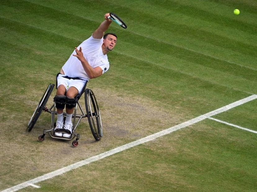 Belgium's Joachim Gerard serves against Japan's Shingo Kunieda during their men's weelchair singles semi final tennis match on the twelfth day of the 2022 Wimbledon Championships at The All England Tennis Club in Wimbledon, southwest London, on July 8, 2022.   SEBASTIEN BOZON / AFP