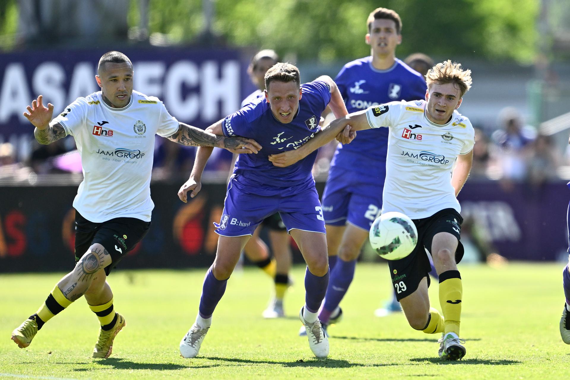 Lokeren's Radja Nainggolan, Patro Eisden's Simon Bammens and Lokeren's Andreas Spegelaere fight for the ball during a soccer match between Patro Eisden Maasmechelen and KSC Lokeren-Temse, Sunday 11 May 2025 in Lokeren, the return leg in the Promotion Play-off finals of the 2024-2025 'Challenger Pro League' 1B second division of the Belgian championship. BELGA PHOTO JOHAN EYCKENS