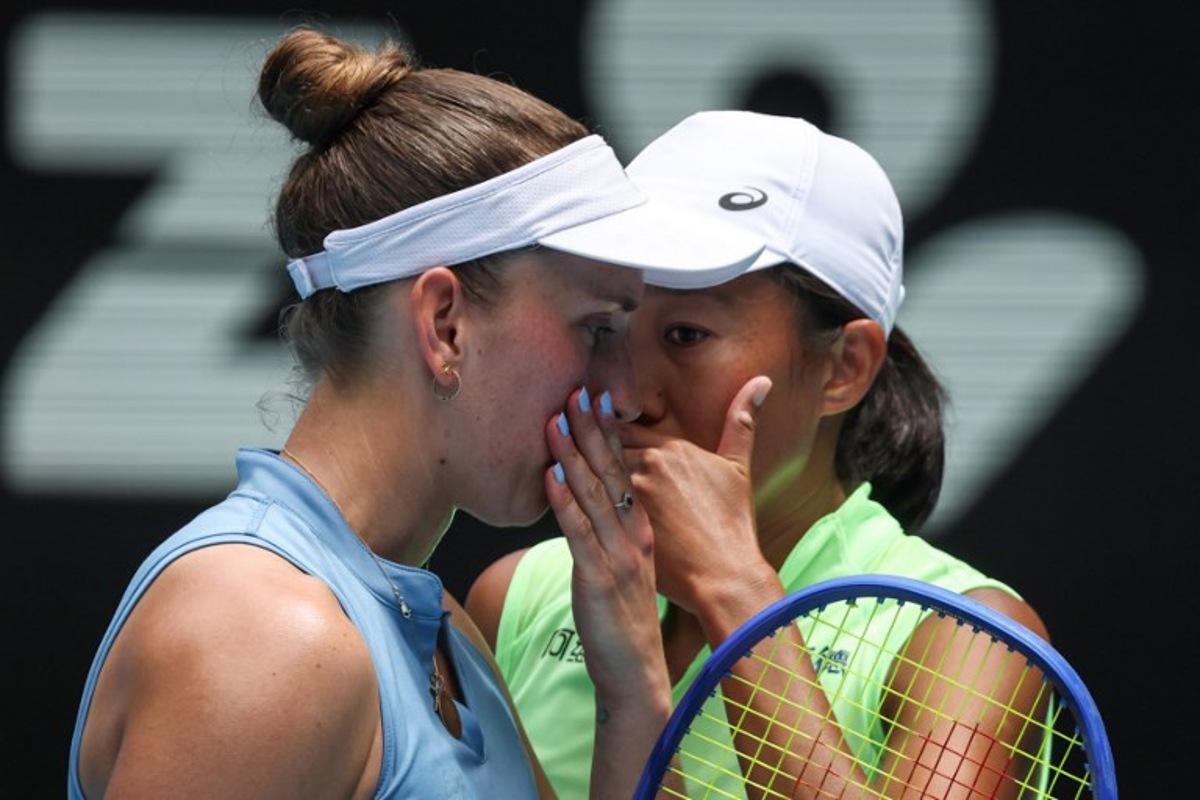Belgium's Elise Mertens talks to partner China's Zhang Shuai (R) during their women's doubles final match against Kazakhstan's Anna Danilina and Serbia's Aleksandra Krunic on day fourteen of the Australian Open tennis tournament in Melbourne on January 31, 2026.  DAVID GRAY / AFP