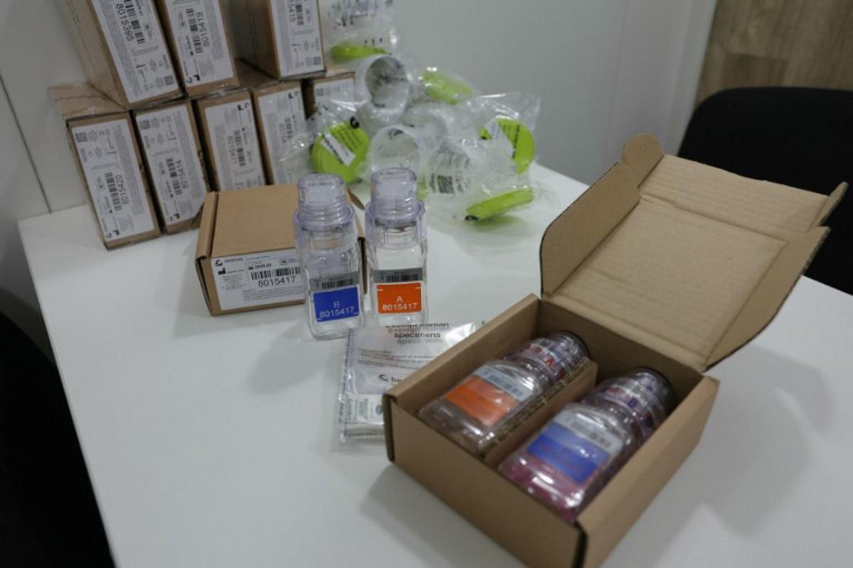 This photograph taken on July 5, 2024, shows anti-doping testing kit materials displayed at the International Testing Agency (ITA) testing facility inside a truck at the finish line of the 7th stage of the 111th edition of the Tour de France cycling race, 25,3 km individual time trial between Nuits-Saint-Georges and Gevrey-Chambertin. The overall leader yellow jersey rider and stage winner are systematically summoned to be tested for doping after the day's stage, along with any rider selected by ITA based on performance or intelligence from the organisation's investigative department. A chaperon escorts the rider to the facility where a supervised urine sample is collected for testing. Thomas SAMSON / AFP