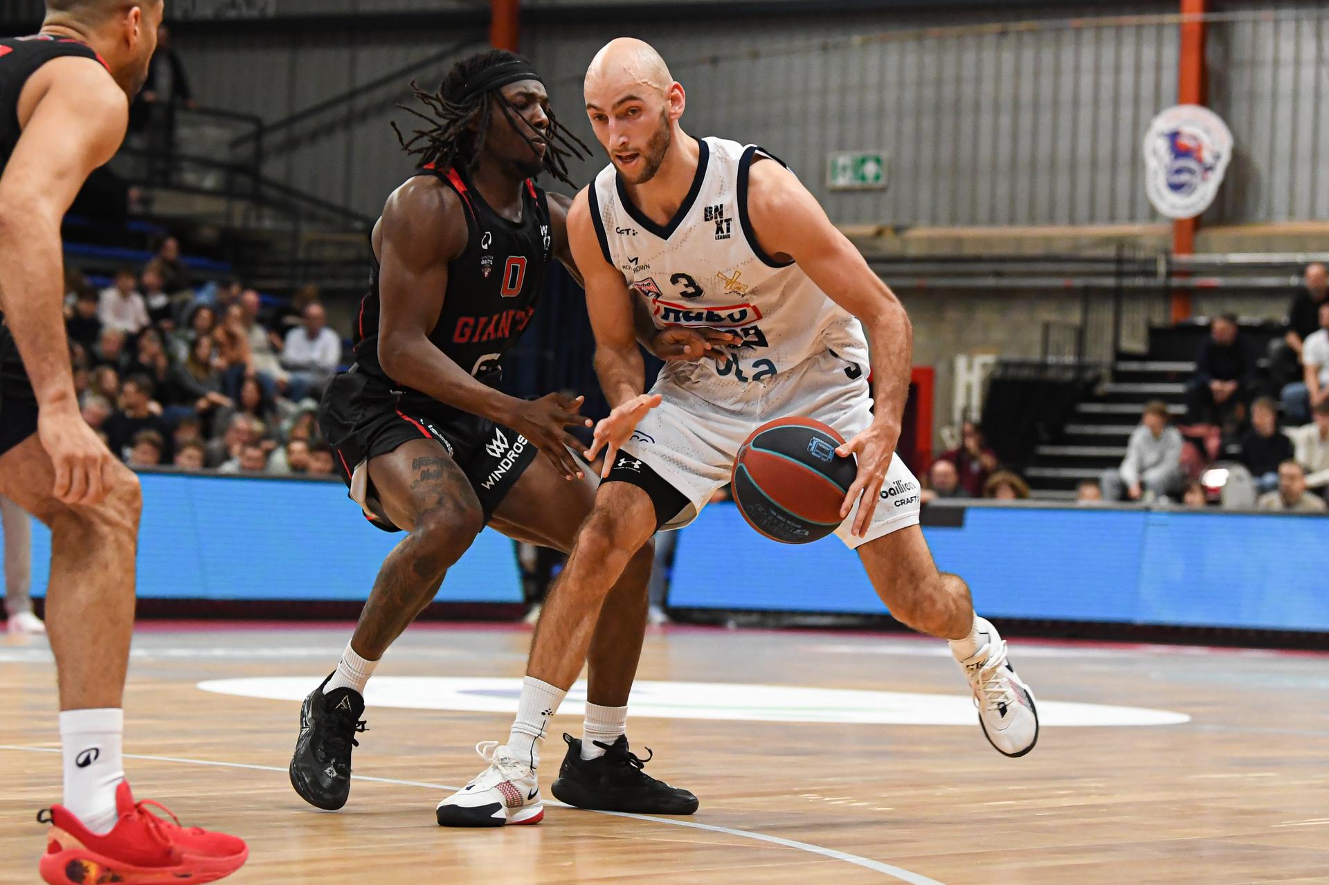 Antwerp's Rasheed Bello and Limburg's Vlarijn Ververs pictured in action during a basketball match between Limburg United and Antwerp Giants, Friday 19 December 2025 in Hasselt, on day 12 of the 'BNXT League' Belgian/ Dutch first division basket championship. BELGA PHOTO JILL DELSAUX