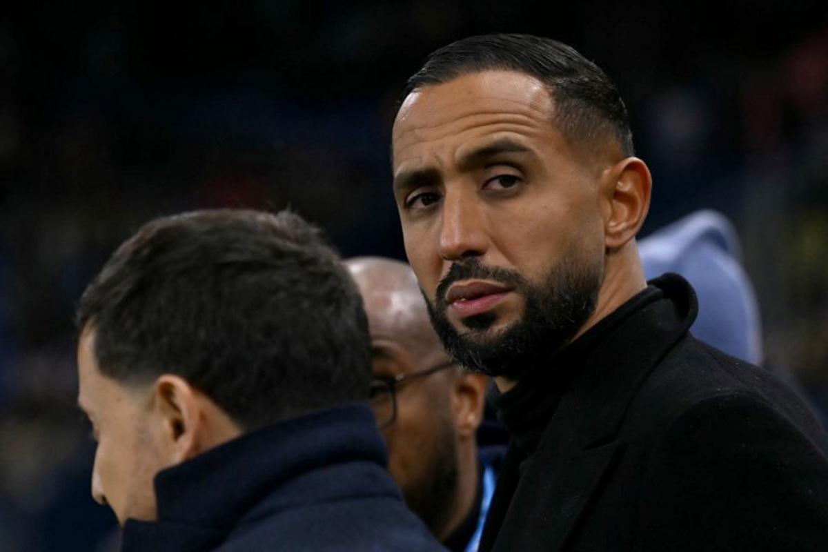 Marseille's French-Moroccan sporting director Medhi Benatia (R) looks on ahead of the French Cup round of 32 football match between FC Bayeux and Olympique de Marseille (OM) at the Michel-d'Ornano Stadium in Caen on January 13, 2026.  LOU BENOIST / AFP