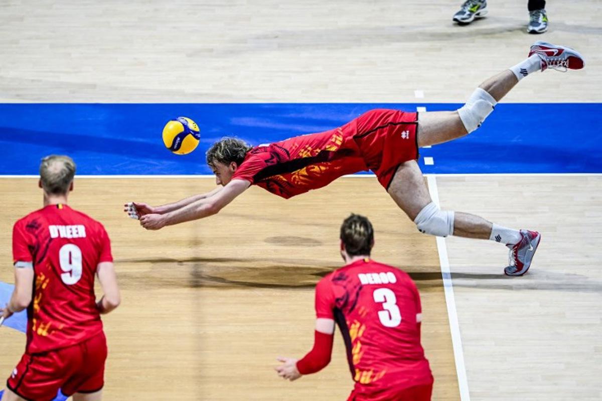 Belgium's Ferre Reggers dives for the ball against Italy during the 2025 Men's Volleyball World Championship at the Araneta Coliseum in Quezon City on September 16, 2025.  SHERWIN VARDELEON / AFP