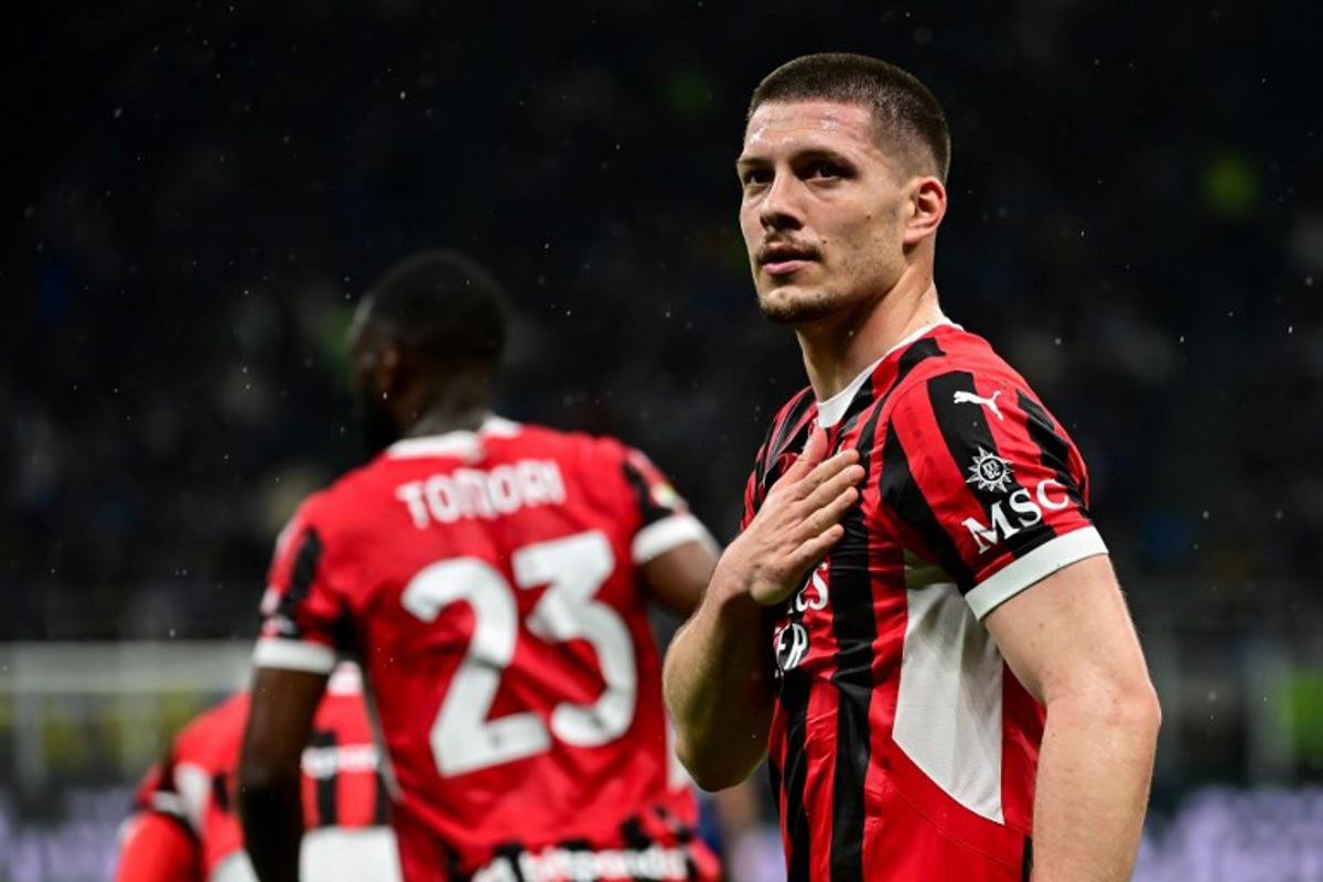 AC Milan's Serbian forward #09 Luka Jovic (R) celebrates after scoring AC Milan's first goal during the Coppa Italia second leg semi-final football match between Inter Milan and AC Milan at the San Siro stadium in Milan on April 23, 2025.  Piero CRUCIATTI / AFP