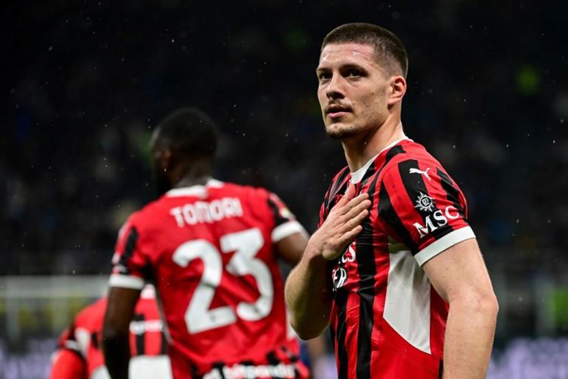 AC Milan's Serbian forward #09 Luka Jovic (R) celebrates after scoring AC Milan's first goal during the Coppa Italia second leg semi-final football match between Inter Milan and AC Milan at the San Siro stadium in Milan on April 23, 2025.  Piero CRUCIATTI / AFP