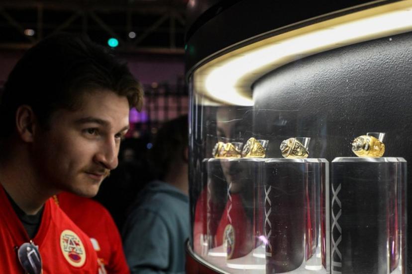 A man looks at a display of super bowl rings at the "A New Era of Immersive NFL Fan Engagement" ahead of Super Bowl LIX, where the Kansas City Chiefs will play the Philadelphia Eagles, in New Orleans, Louisiana, on February 8, 2025.  CHANDAN KHANNA / AFP