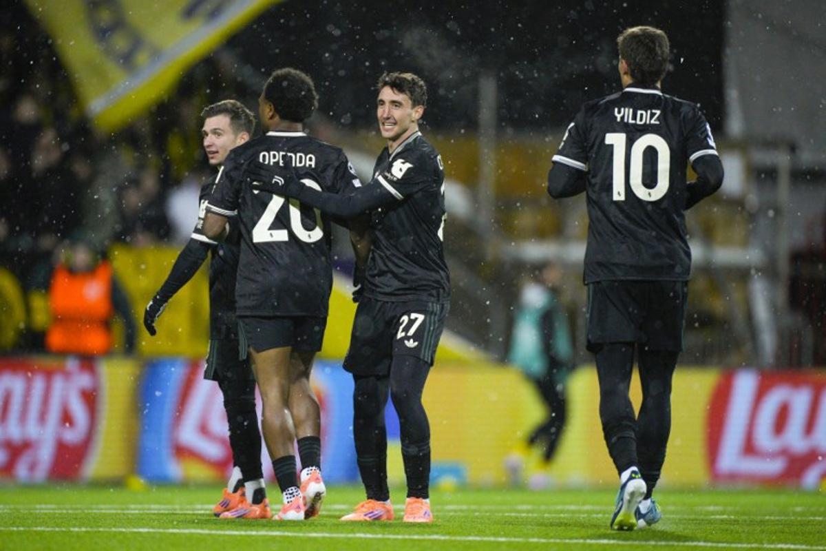 Juventus' Belgian forward #20 Lois Openda (L) celebrates with Juventus' Italian defender #27 Andrea Cambiaso celebrates after scoring the equalising goal during the UEFA Champions League football match between Bodoe/Glimt and Juventus Turin in Bodoe, on November 25, 2025.  Stian Lysberg Solum / NTB / AFP