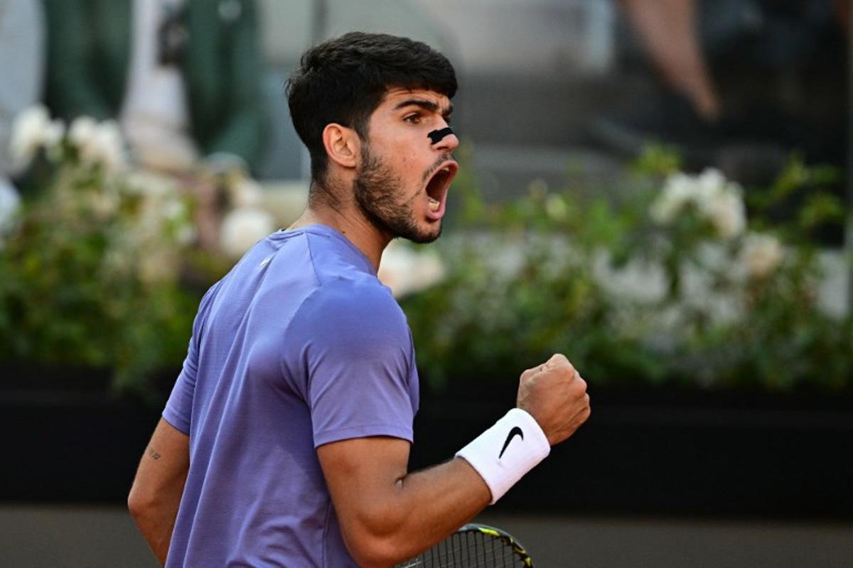 Spain's Carlos Alcaraz reacts during his men's singles final match against Italy's Jannik Sinner for the ATP Rome Open tennis tournament at Foro Italico in Rome on May 18, 2025.   Tiziana FABI / AFP