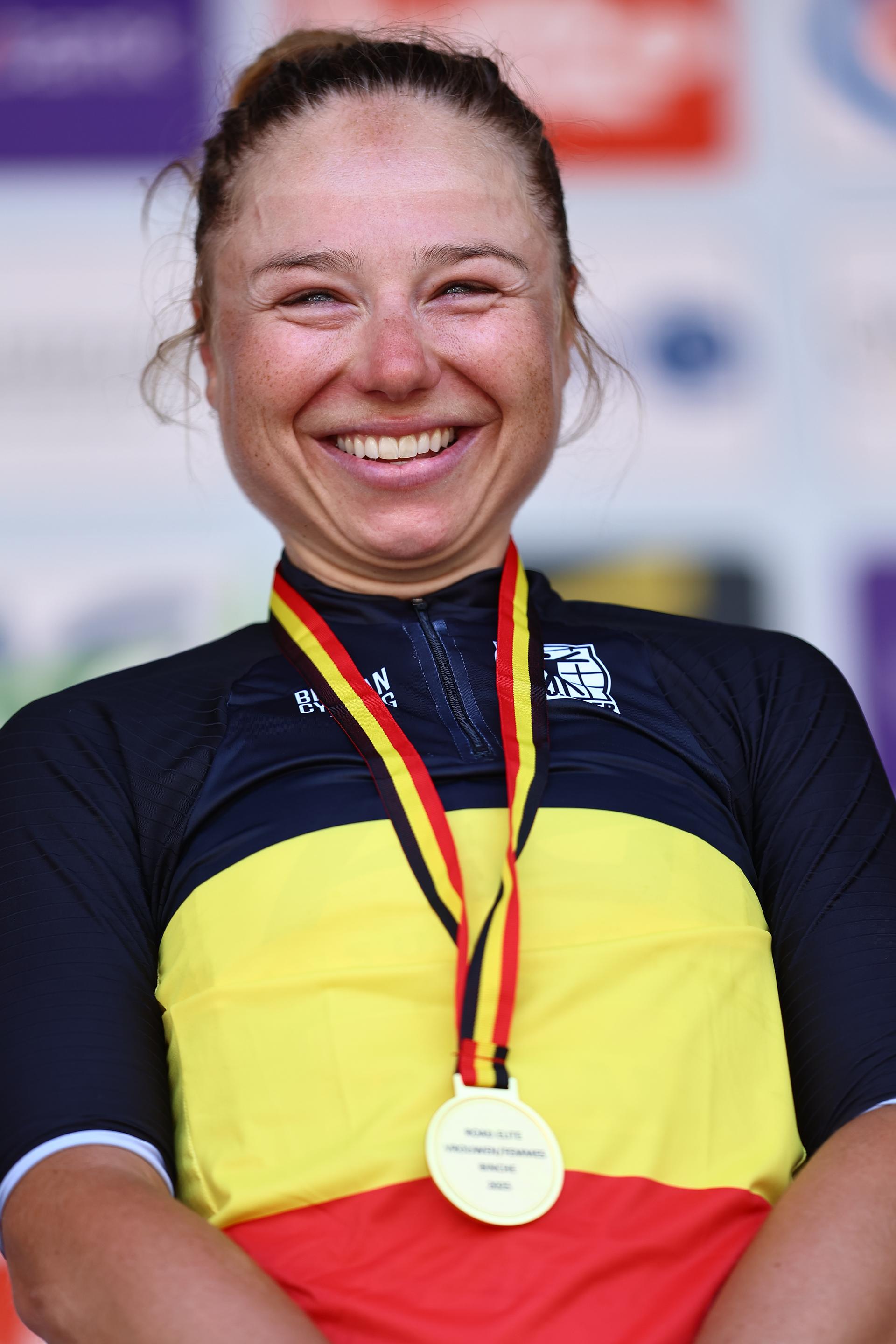 Belgian Justine Ghekiere celebrates on the podium in the national jersey after winning the women's elite road race of the Belgian Cycling Championships, 132,8 km from and to the Grand Place square in Binche on Sunday 29 June 2025. BELGA PHOTO DAVID PINTENS