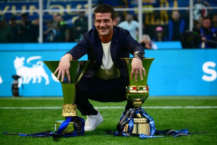 Inter Milan's Romanian head coach Cristian Chivu poses with the trophies for the Italian Cup and the 21st scudetto (Italian Championship victory) at San Siro stadium after the Italian Serie A football match between Inter Milan and Hellas Verona in Milan, on May 17, 2026.  Marco BERTORELLO / AFP