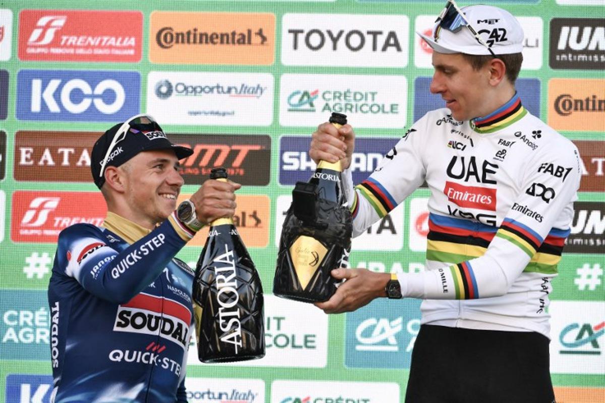 UAE Team Emirates's Slovenian rider Tadej Pogacar celebrates his victory on the podium alongside second-placed Soudal Quick-Step's Belgian rider Remco Evenepoel (L) after the 119th edition of the Giro di Lombardia (Tour of Lombardy), a 238km cycling race from Como to Bergamo on October 11, 2025.  Marco BERTORELLO / AFP