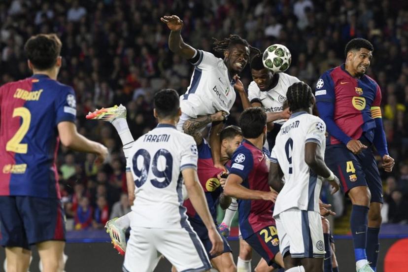 Inter Milan's Dutch defender #02 Denzel Dumfries (C,R) scores his team's third goal during the UEFA Champions League semi final first leg football match between FC Barcelona and Inter Milan at the Estadi Olimpic Lluis Companys in Barcelona on April 30, 2025.  Josep LAGO / AFP