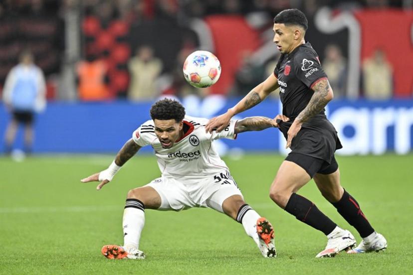 Frankfurt's German-Nigerian defender #34 Nnamdi Collins (L) and Bayer Leverkusen's Argentinian midfielder #06 Ezequiel Fernandez vie for the ball during the German first division Bundesliga football match between Bayer 04 Leverkusen and Eintracht Frankfurt in Leverkusen, western Germany on September 12, 2025.  INA FASSBENDER / AFP