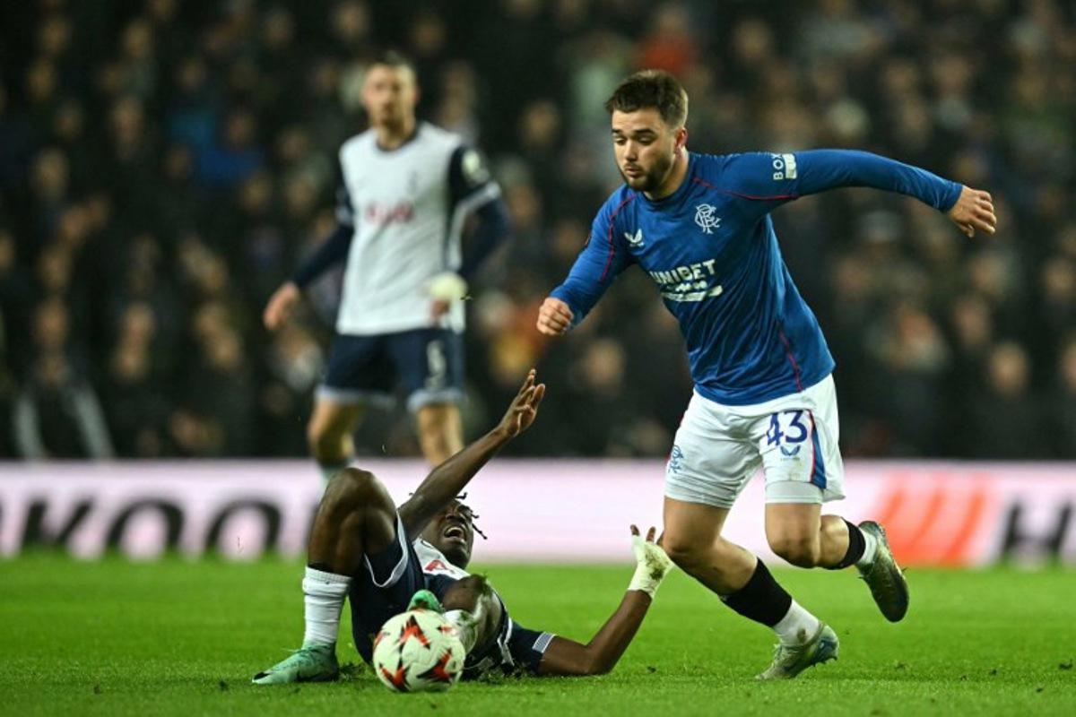 Tottenham Hotspur's Malian midfielder #08 Yves Bissouma reacts on the floor after fighting for the ball with Rangers' Belgian midfielder #43 Nicolas Raskin during the UEFA Europa League, League Phase football match between Rangers and Tottenham Hotspur at the Ibrox Stadium in Glasgow on December 12, 2024.  ANDY BUCHANAN / AFP
