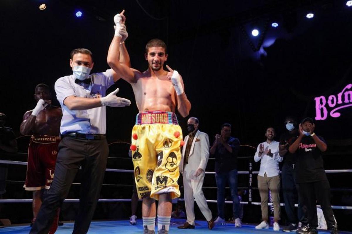 French boxer Milan Prat (C) celebrates after winning his fight against French boxer Jonathan Okito (L) during the Fighting Nation box evening, the first post covid indoor event, inside the Bormann circus in Paris, on July 30, 2020.  GEOFFROY VAN DER HASSELT / AFP TO GO WITH AFP STORY by Clement VARANGES

