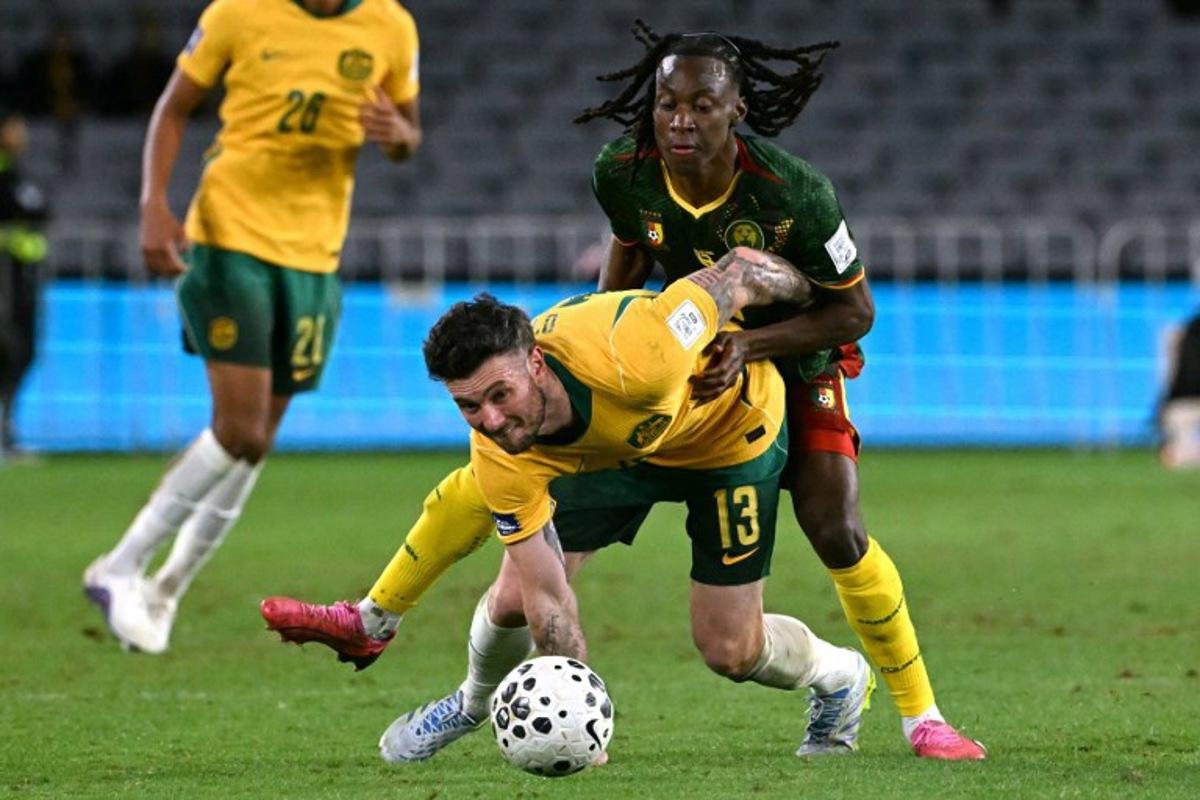 Australia's Aiden O'Neill (L) reacts after being tackled by Cameroon's Ryan Fosso (R) during the international friendly football match between Australia and Cameroon at Stadium Australia in Sydney on March 27, 2026.  SAEED KHAN / AFP