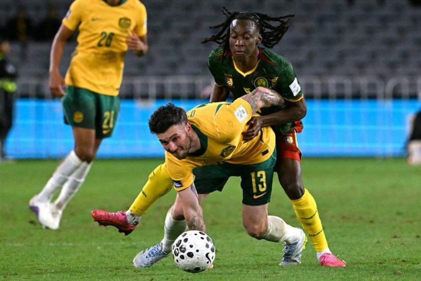 Australia's Aiden O'Neill (L) reacts after being tackled by Cameroon's Ryan Fosso (R) during the international friendly football match between Australia and Cameroon at Stadium Australia in Sydney on March 27, 2026.  SAEED KHAN / AFP