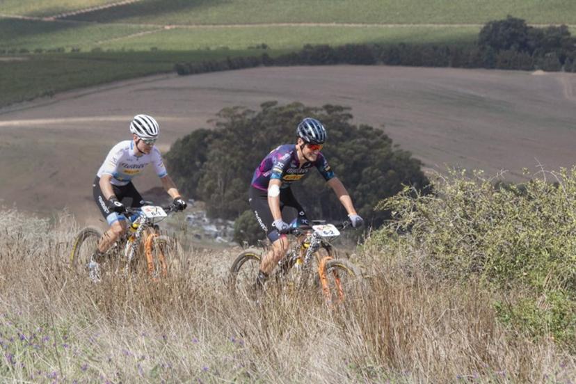 Fabian Rabensteiner (R) and teammate, Wout Alleman, ride during the prologue stage of the 2023 Cape Epic mountain bike stage race, in Durbanville, near Cape Town on March 19, 2023.  The Cape Epic, in which two riders race as a team, is widely known as one of the foremost mountain bike stage race in the world, with the riders from all around the world covering a distance of approximately 700  kilometres, and gaining over 16000m in height, over eight days of racing. RODGER BOSCH / AFP