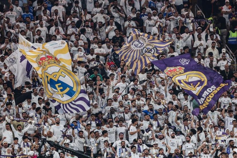 Real Madrid's fans cheer for their team during the Spanish Super Cup final football match between FC Barcelona and Real Madrid at the King Abdullah Stadium in Jeddah on January 11, 2026.  Haitham AL-SHUKAIRI / AFP