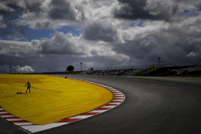 A worker paints the track at the Algarve International Circuit in Portimao on April 29, 2021 ahead of the Portuguese Formula One Grand Prix.  PATRICIA DE MELO MOREIRA / AFP