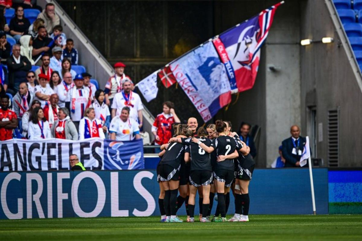 Arsenal's players celebrate after scoring a goal during the UEFA Women's Champions League semi-final second leg football match between Lyon and Arsenal at the Groupama Stadium in Decines-Charpieu, central-eastern France on April 27, 2025.  OLIVIER CHASSIGNOLE / AFP