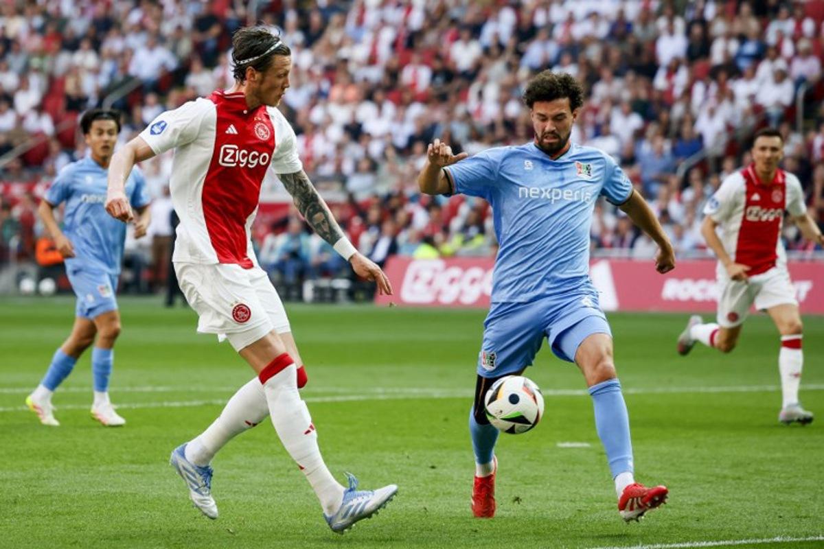 Ajax's Dutch forward #19 Wout Weghorst (L) fights for the ball with NEC's Dutch defender #03 Philippe Sandler during the Dutch Eredivisie football match between Ajax Amsterdam and and NEC Nijmegen at the Johan Cruijff ArenA in Amsterdam on May 11, 2025.  Koen van Weel / ANP / AFP