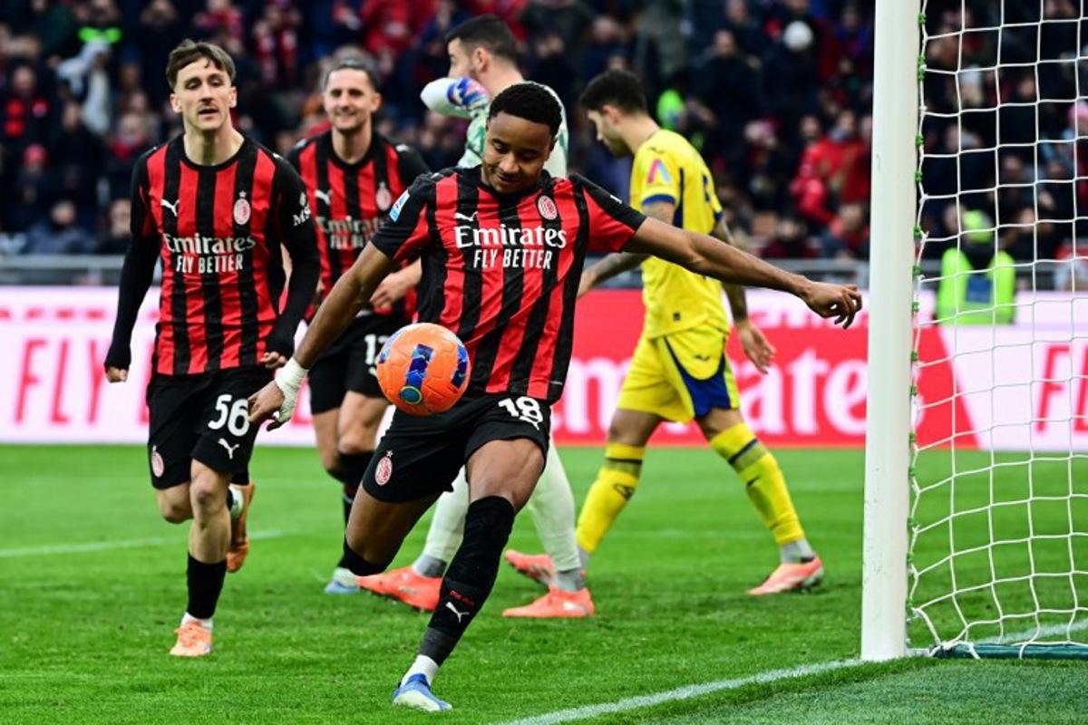 AC Milan's French forward #18 Christopher Nkunku (C) celebrates after scoring his team second goal during the Italian Serie A football match between AC Milan and Hellas Verona at the San Siro stadium in Milan, northern Italy, on December 28, 2025.  Piero CRUCIATTI / AFP