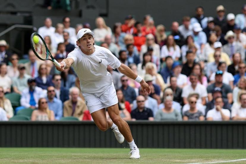 Australia's Alex De Minaur plays a forehand return to Serbia's Novak Djokovic during their men's singles fourth round tennis match on the eighth day of the 2025 Wimbledon Championships at The All England Lawn Tennis and Croquet Club in Wimbledon, southwest London, on July 7, 2025.  Adrian Dennis / AFP
