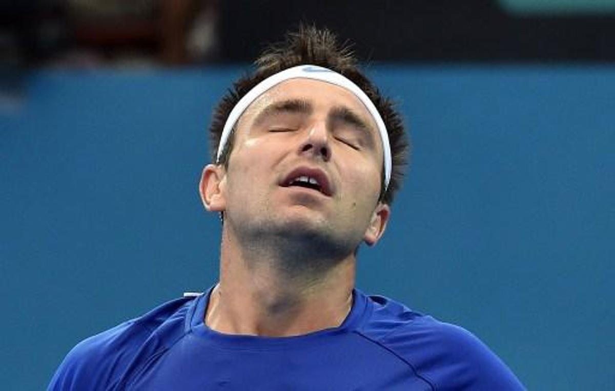 Marinko Matosevic of Australia reacts while playing against Steve Johnson of the US during their men's singles match on day three of the Brisbane International tennis tournament in Brisbane on January 6, 2015.   AFP PHOTO / Saeed KHAN IMAGE RESTRICTED TO EDITORIAL USE - STRICTLY NO COMMERCIAL USE IMAGE RESTRICTED TO EDITORIAL USE - STRICTLY NO COMMERCIAL USE

