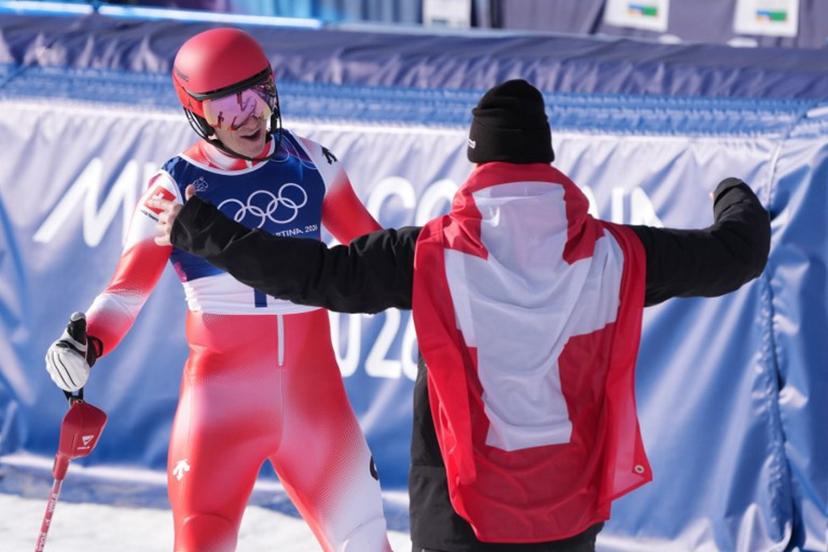 Switzerland's Tanguy Nef (L) and Switzerland's Franjo von Allmen react in the finish area after the slalom run of the men's team combined alpine skiing event during the Milano Cortina 2026 Winter Olympic Games at the Stelvio Ski Centre in Bormio (Valtellina) on February 9, 2026.   Dimitar DILKOFF / AFP
