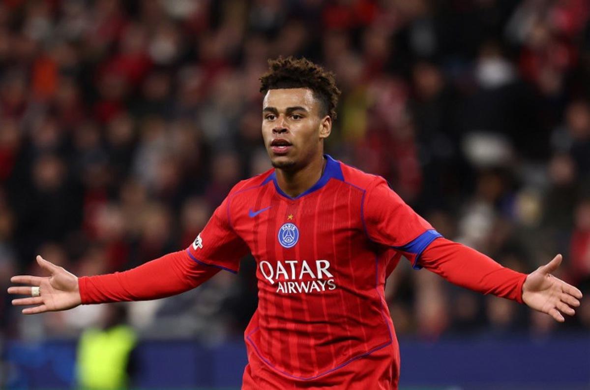 Paris Saint-Germain's French midfielder #14 Desire Doue celebrates scoring the 1-4 goal with his teammates during the UEFA Champions League football match between Bayer 04 Leverkusen and Paris Saint-Germain (PSG) at the BayArena stadium in Leverkusen, western Germany on October 21, 2025.  FRANCK FIFE / AFP