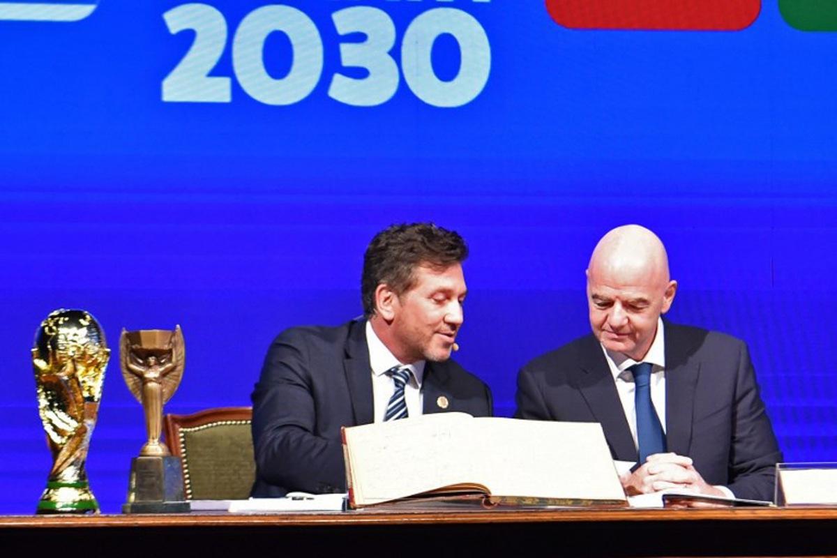 Conmebol's President Alejandro Dominguez (L) and FIFA Presdient Gianni Infantino (R) sign a book of minutes of the 2030 World Cup during Conmebol's 78th Ordinary Congress in Luque, Paraguay on April 11, 2024.  NORBERTO DUARTE / AFP