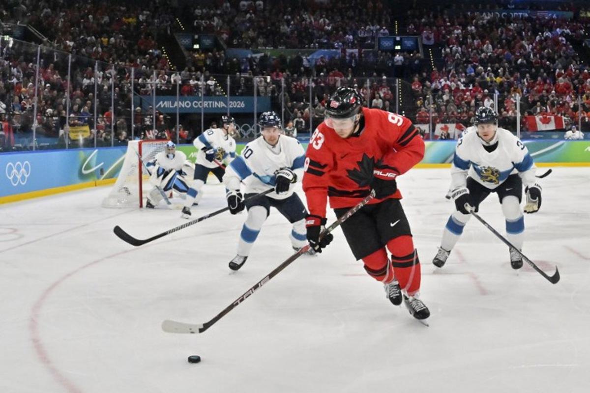 Canada's #93 Mitch Marner (C) controls the puck during the men's play-off semi-final ice hockey match between Canada and Finland at the Milano Santagiulia Ice Hockey Arena during the Milano Cortina 2026 Winter Olympic Games in Milan, on February 20, 2026.  Alexander NEMENOV / AFP