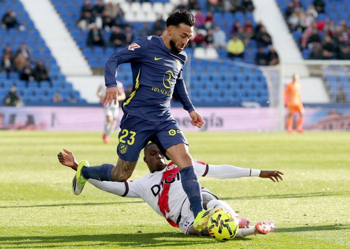 Atletico Madrid's Argentine midfielder #23 Nico Gonzalez fights for the ball with Rayo Vallecano's Senagalese defender #32 Nobel Mendy (down) during the Spanish league football match between Rayo Vallecano de Madrid and Club Atletico de Madrid at Butarque Stadium in Leganes, south of Madrid on February 15, 2026.  Pierre-Philippe MARCOU / AFP