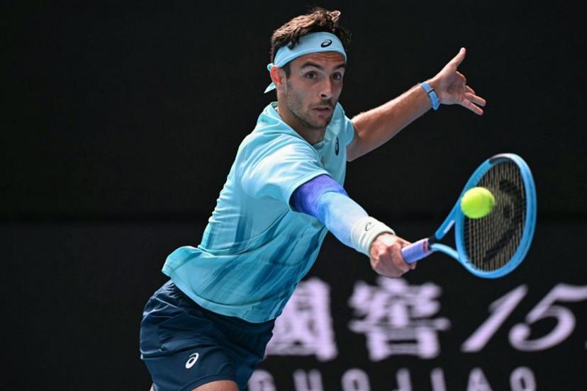 Italy's Lorenzo Musetti hits a return to Serbia's Novak Djokovic during their men's singles quarter-final match on day eleven of the Australian Open tennis tournament in Melbourne on January 28, 2026.  WILLIAM WEST / AFP