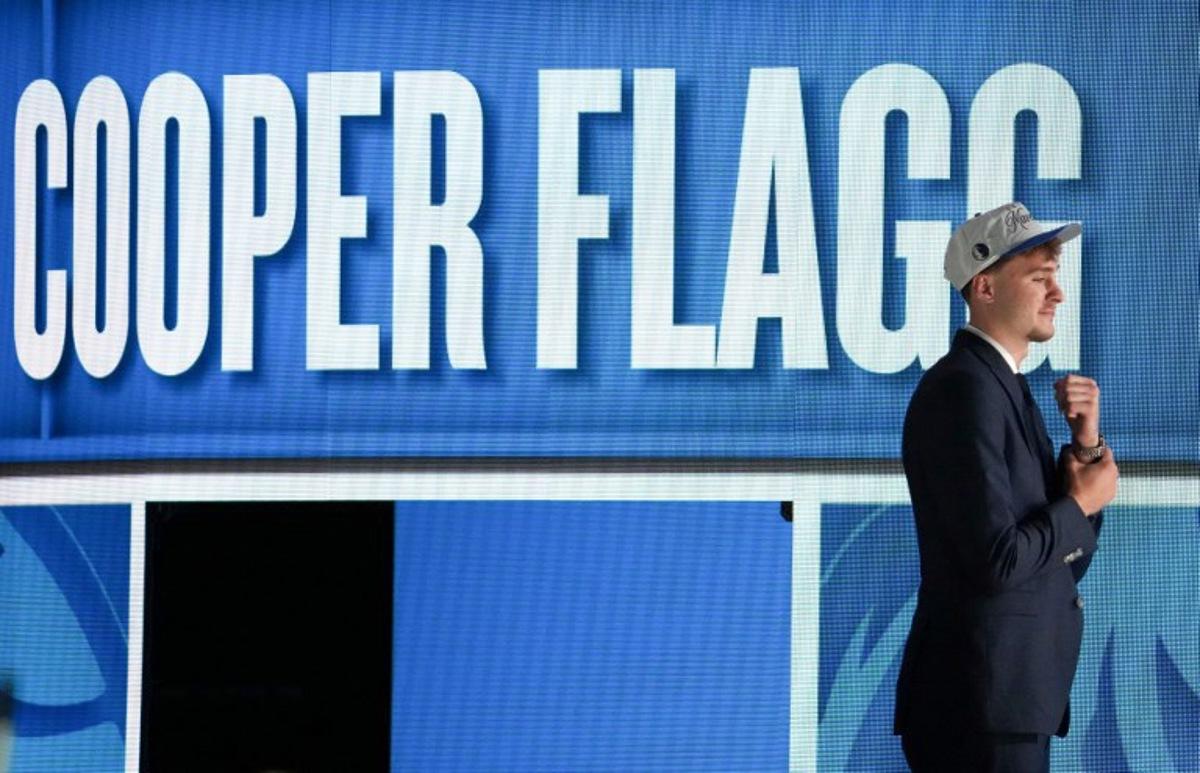 US basketball player Cooper Flagg steps on stage after being selected first overall by the Dallas Mavericks during the opening round of the 2025 NBA Draft at Barclays Center in Brooklyn, New York, on June 25, 2025. Versatile US college teen star Cooper Flagg was selected first overall in the NBA draft on June 25 by the Dallas Mavericks, where he'll join a star-laden team already touted as a playoff threat next season. Flagg, a consensus pick as the top US college player as a freshman at Duke University last season, is the second-youngest player taken first overall.  TIMOTHY A. CLARY / AFP