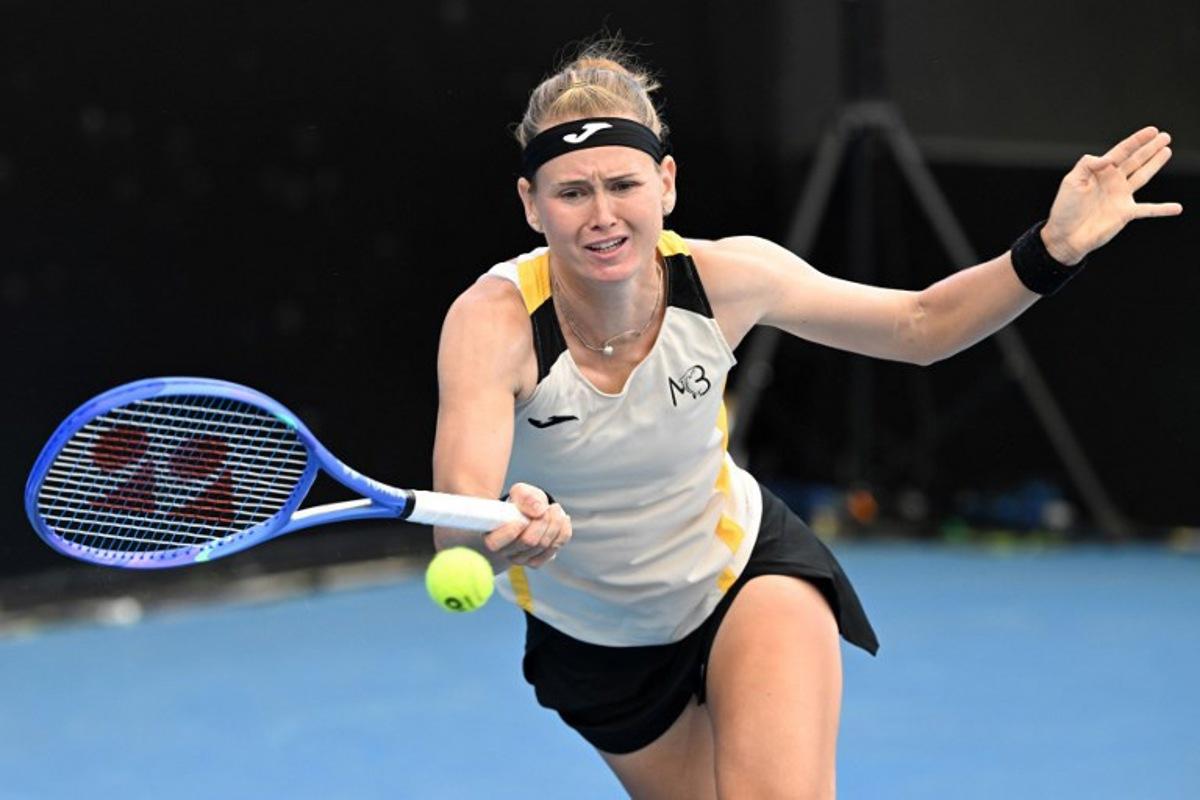 Marie Bouzkova of the Czech Republic hits a return during her women's singles match against Paula Badosa of Spain during the 2026 Adelaide International Tennis Tournament at Memorial Drive Tennis Club in Adelaide on January 12, 2026.   Michael ERREY / AFP