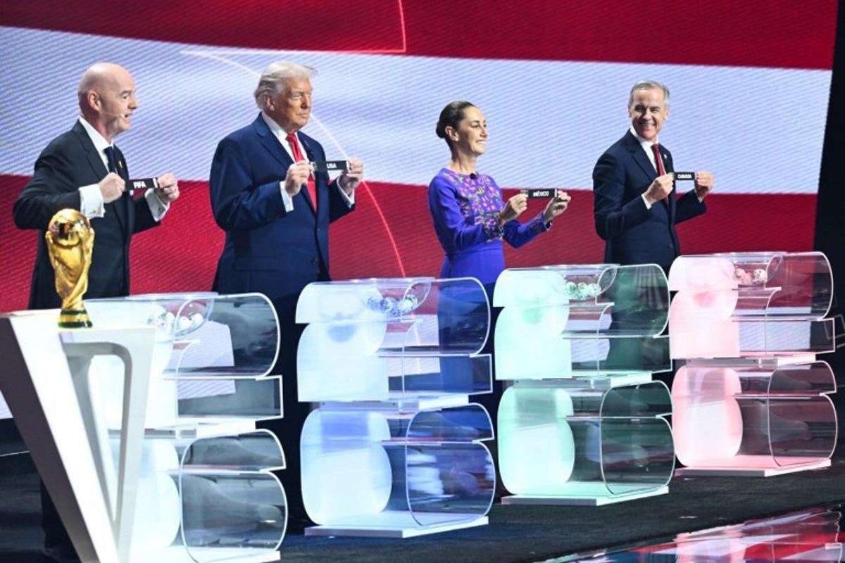 (From L) FIFA President Gianni Infantino, US President Donald Trump, Mexico's President Claudia Sheinbaum and Canada's Prime Minister Mark Carney pose with their cards during the draw for the 2026 FIFA Football World Cup taking place in the US, Canada and Mexico, at the Kennedy Center, in Washington, DC, on December 5, 2025.  SAUL LOEB / AFP