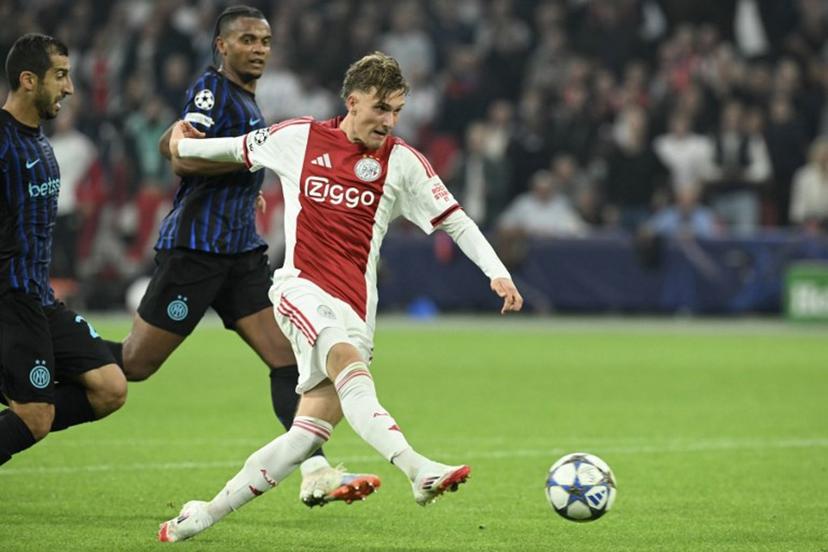 Ajax's Belgian forward #11 Mika Godts shoots the ball during the UEFA Champions League first round day 1 football match between Ajax Amsterdam and Inter Milan, at the Johan Cruijff ArenA in Amsterdam, on September 17, 2025.  NICOLAS TUCAT / AFP