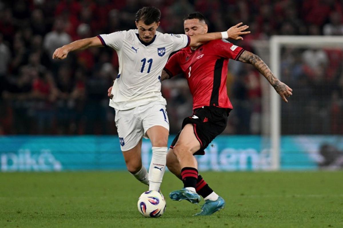Serbia's midfielder #11 Lazar Vujadin Samardzic (L) and Albania's forward #07 Rey Manaj fight for the ball during the 2026 World Cup qualifiers Europe zone, 1st round group K football match between Albania and Serbia at the Air Albania Stadium in Tirana on June 7, 2025.  Armend NIMANI / AFP