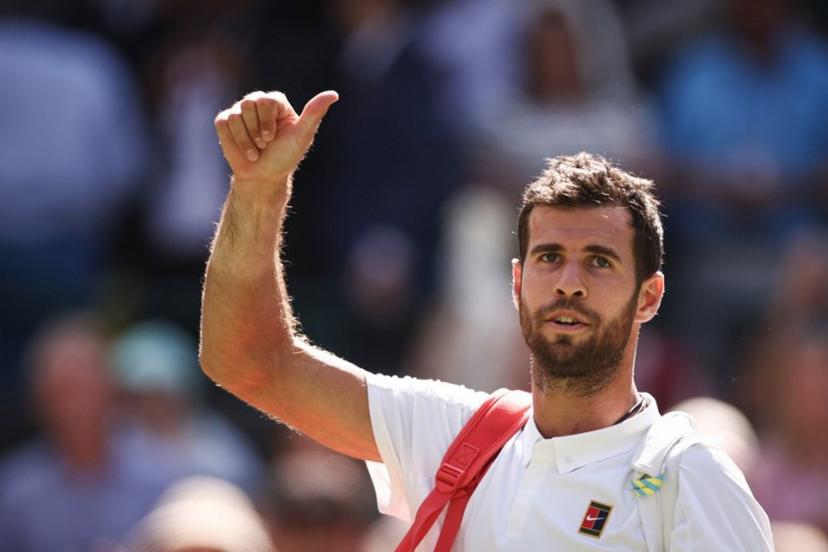 Russia's Karen Khachanov waves to the crowd as he leaves the court after losing against US player Taylor Fritz at the end of their men's singles quarter-final tennis match on the ninth day of the 2025 Wimbledon Championships at The All England Lawn Tennis and Croquet Club in Wimbledon, southwest London, on July 8, 2025.  HENRY NICHOLLS / AFP