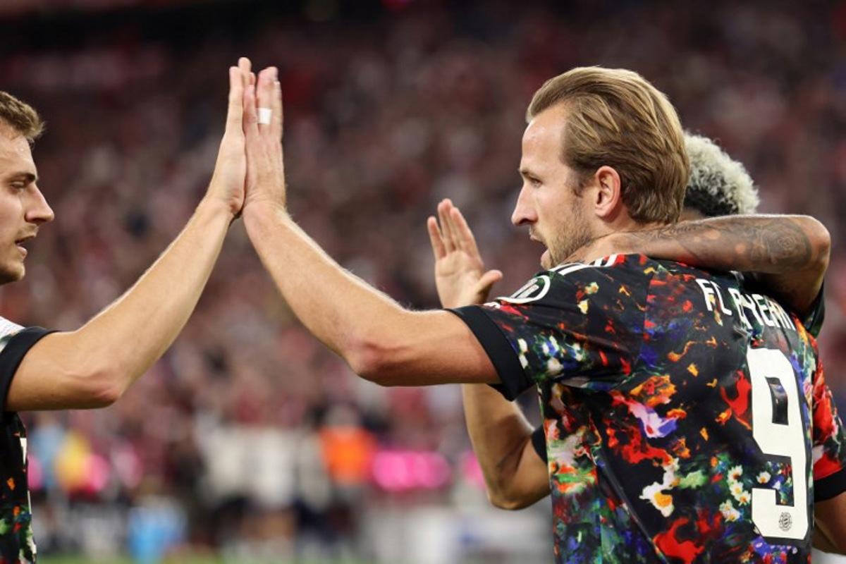 Bayern Munich's English forward #09 Harry Kane celebrates scoring his team's second goal with teammates during the German first division Bundesliga football match between FC Bayern Munich and Union Berlin in Munich, southern Germany on September 18, 2026.  Alexandra BEIER / AFP