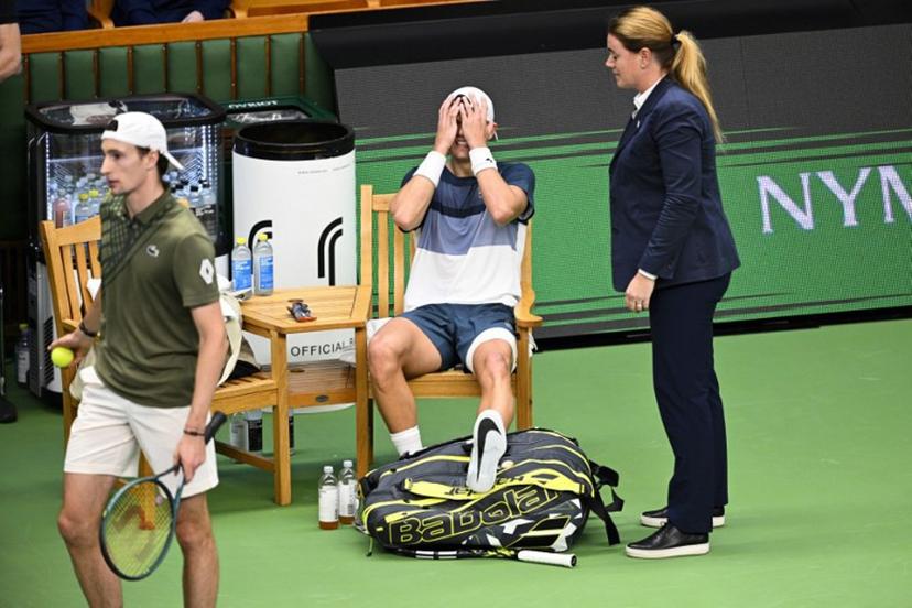 Denmark's Holger Rune (C) reacts after injurung his foot during the semi-final of the BNP Paribas Nordic Open tennis tournament against France's Ugo Humbert (L) at the Royal Swedish Tennis Hall in Stockholm, Sweden, on October 18, 2025.   Anders WIKLUND / TT NEWS AGENCY / AFP