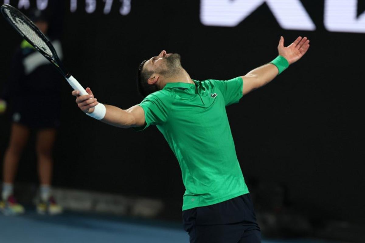 Serbia's Novak Djokovic reacts on a point to Italy's Jannik Sinner during their men's singles semi-final match on day thirteen of the Australian Open tennis tournament in Melbourne on January 31, 2026.  Martin KEEP / AFP