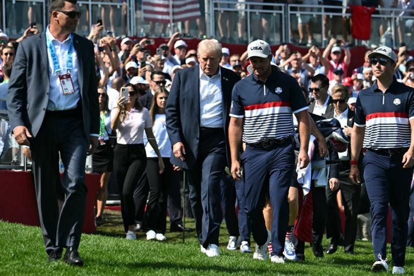 US President Donald Trump walks with pro-golfer Bryson DeChambeau (2R) as he attends the 45th Ryder Cup golf competition at Bethpage Black Course in Farmingdale, New York, on September 26, 2025.  Mandel NGAN / POOL / AFP